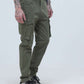 Olive green cargo pants with six large pockets, designed for durability and style, modeled by a tattooed male.