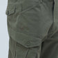 Close-up of Presso Olive cargo pants showcasing large pockets and durable fabric, ideal for modern adventurers.