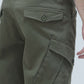 Olive green cargo pants showcasing large pockets and rugged design, perfect for adventure.